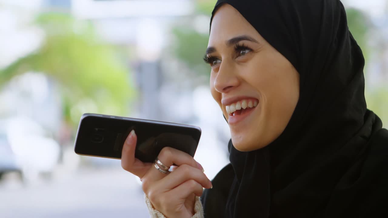 Woman in hijab talking on the phone 4k