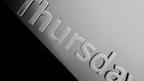 close up view of the word thursday on a metal surface