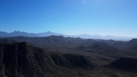 pan into the desert mountains in baja mexico sierra de la laguna mountain range while off-roading with a jeep