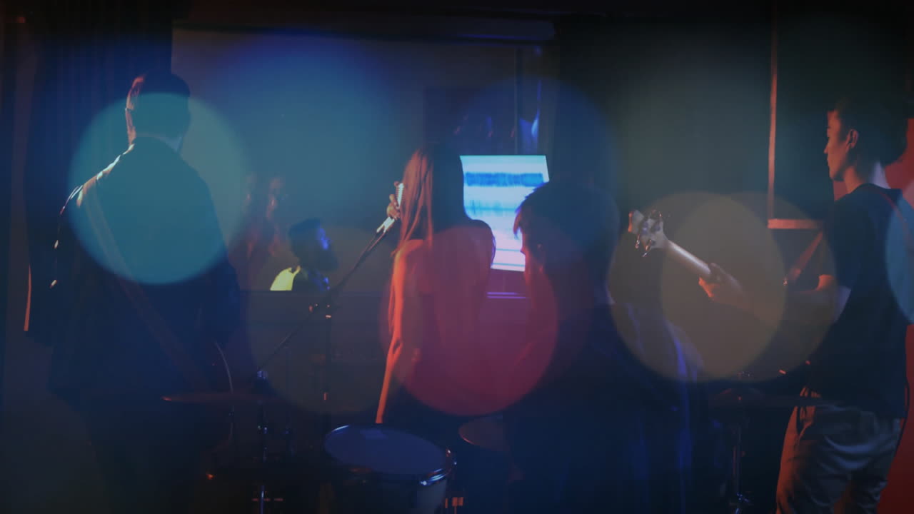 Female vocalist singing for music mixing with band in dark studio with animated waveforms floating