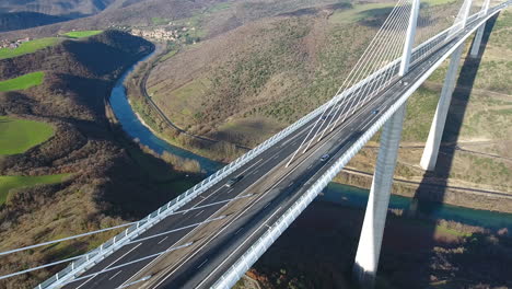Flying-towards-Millau-Viaduct-over-river-Tarn-sunny-day.-Aerial-drone-shot