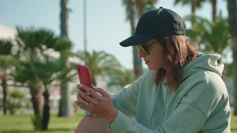 woman using a smartphone in a park