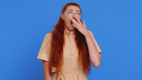 woman with red hair smiles and looks up with her hands clasped