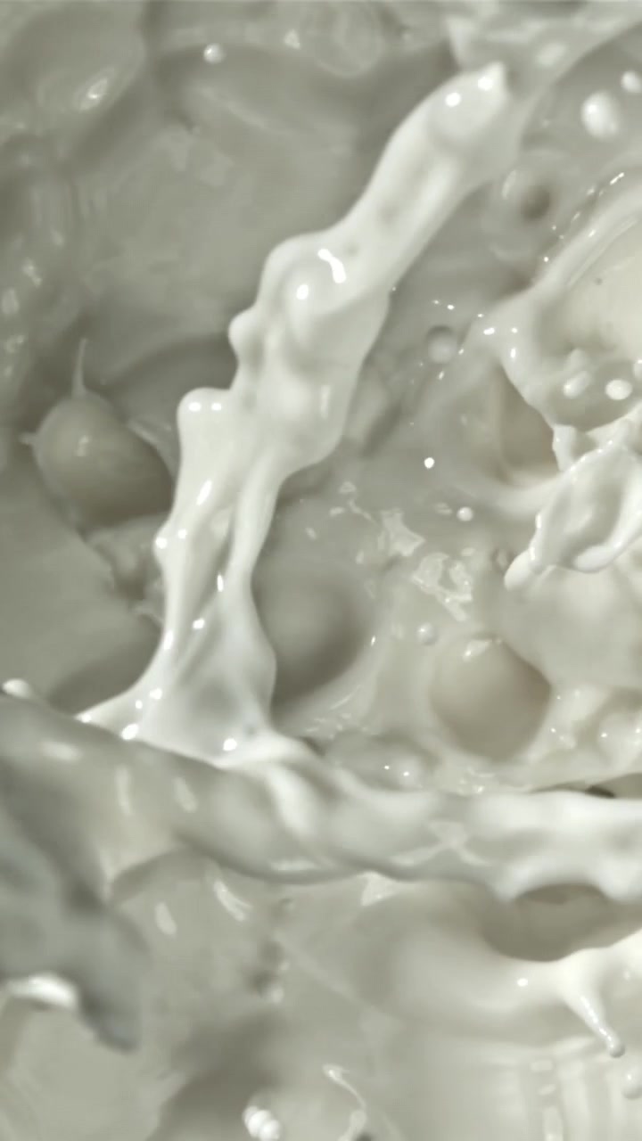 Slow Motion Milk Splashing and Pouring, Creating Dynamic Liquid Patterns