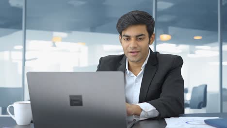 happy indian manager working in office