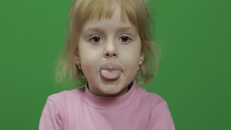 Girl-sitting-at-the-table-and-drinks-yogurt-milk.-Funny-milk-mustache