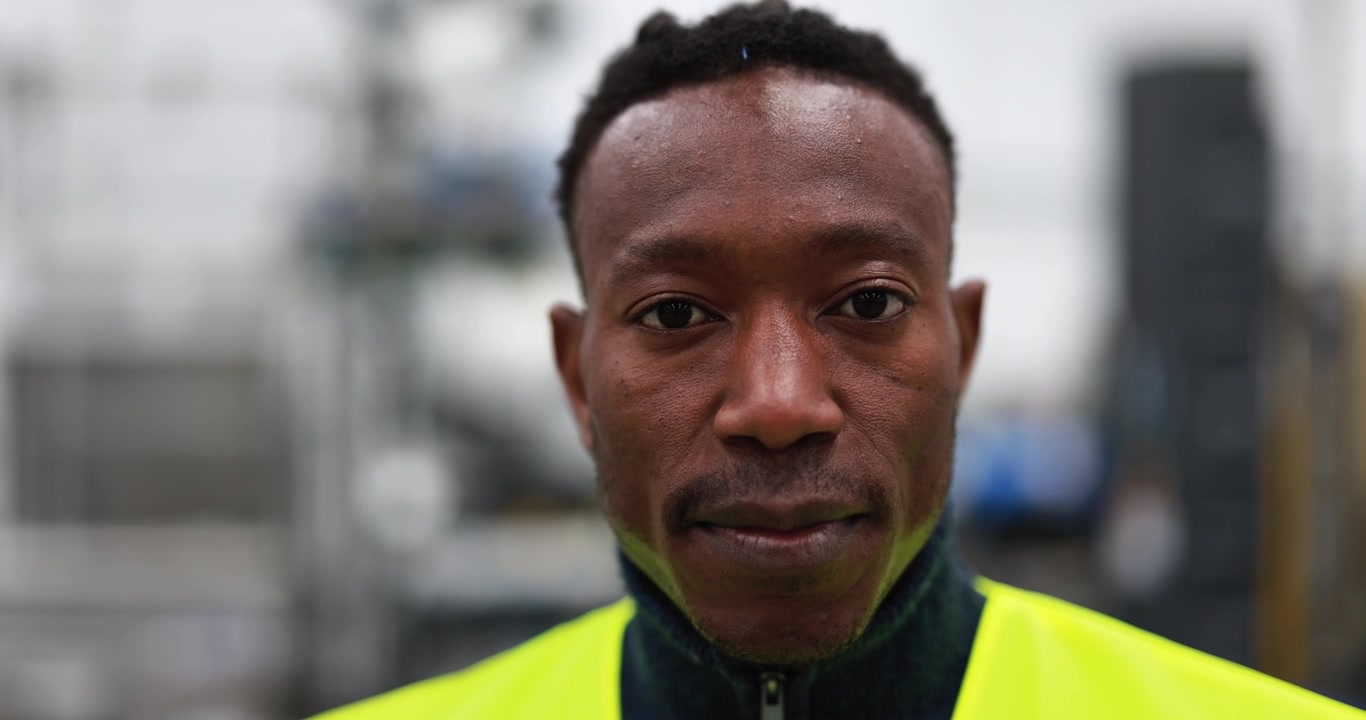 Portrait of a Focused Male Construction Worker in High Visibility Vest