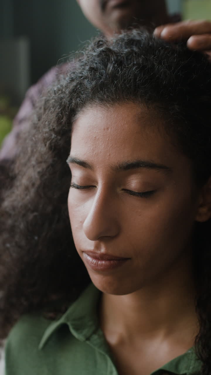 Woman with curly hair getting her hair styled