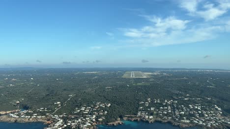 aerial view from a jet cockpit approaching to land to menorca airport, balearic islands, spain