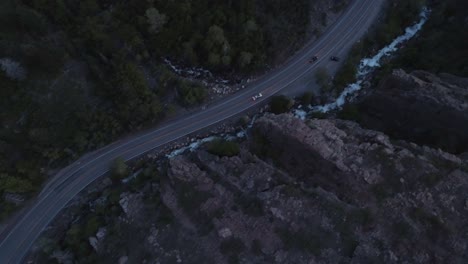 High-Altitude-shot-tracking-two-cars-coming-down-Big-Cottonwood-Canyon,-Utah