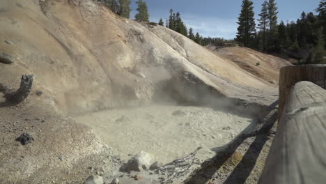 slow motion of a boiling muddpot at lassen volcanic national park showing the boiling mud and sulfur steam rising above