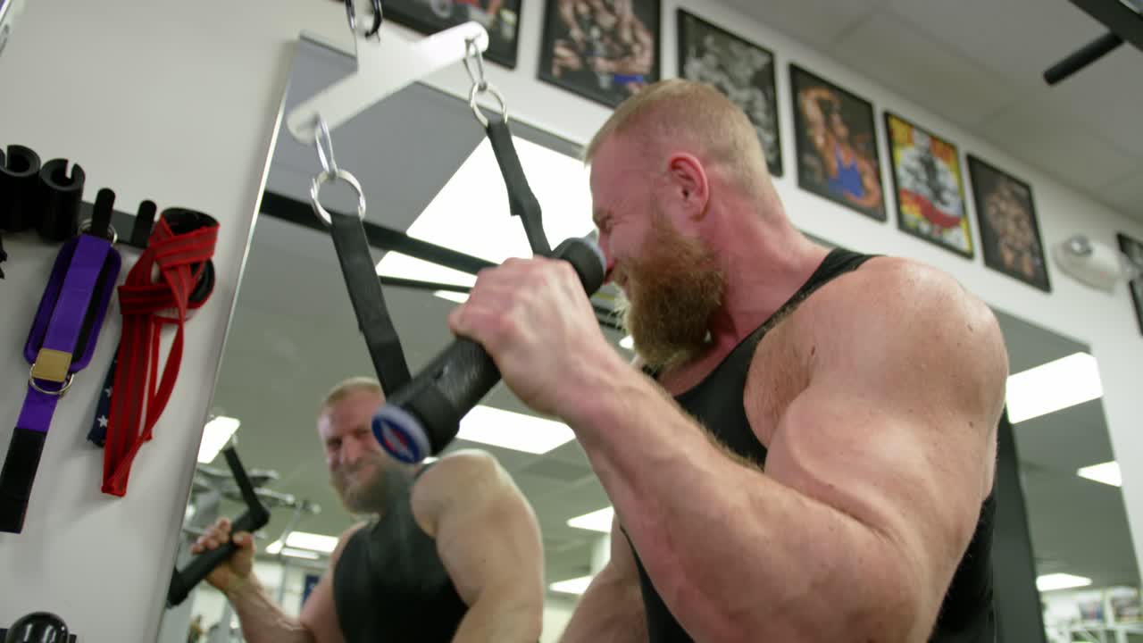 Strong bodybuilder lifting weights. Athletic person effort