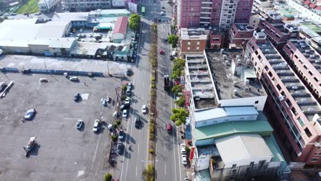 a busy urban area with cars and buildings, sunny day, aerial view