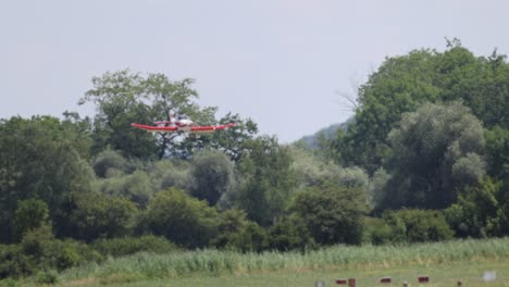 Tracking-shot-of-light-aircraft-during-landing-approach-on-small-rural-forest-airport-in-Switzerland