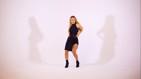 Romanian-Gypsy-woman-warming-up-starting-move-dancing-spinning-around-jumping-waving-feeling-confident-wearing-black-dress-loose-belt-black-heels-swinging-arms-around-shaking-head-casting-shadows