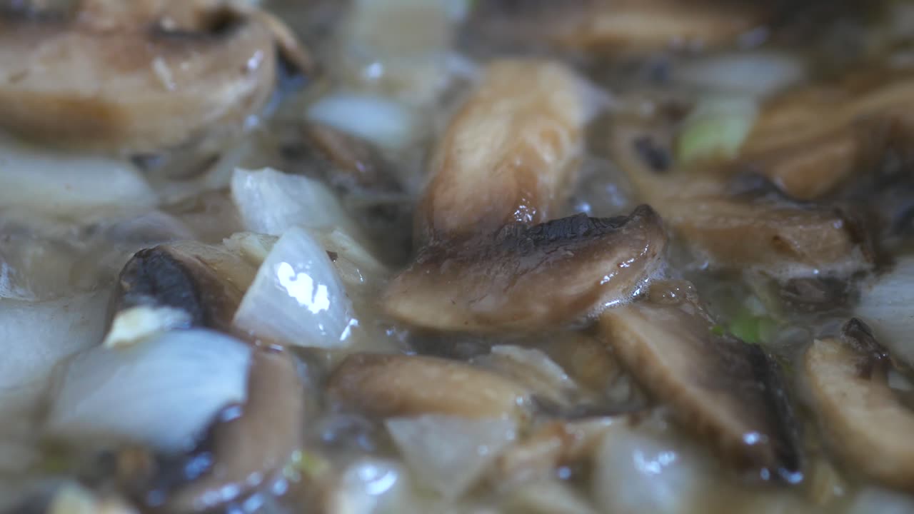 Cooking Mushrooms and Onions in a Pan