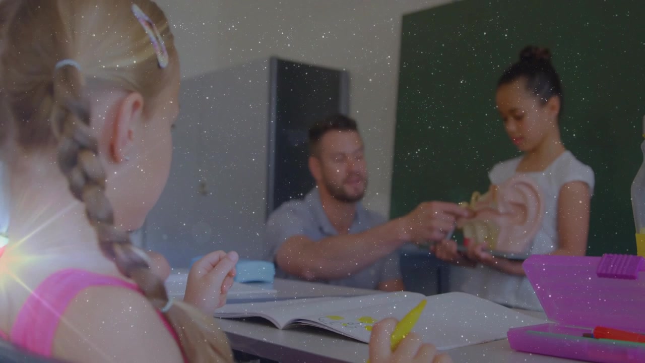 Teacher gesturing to teen student showing skull model in classroom child with pencil writing notes
