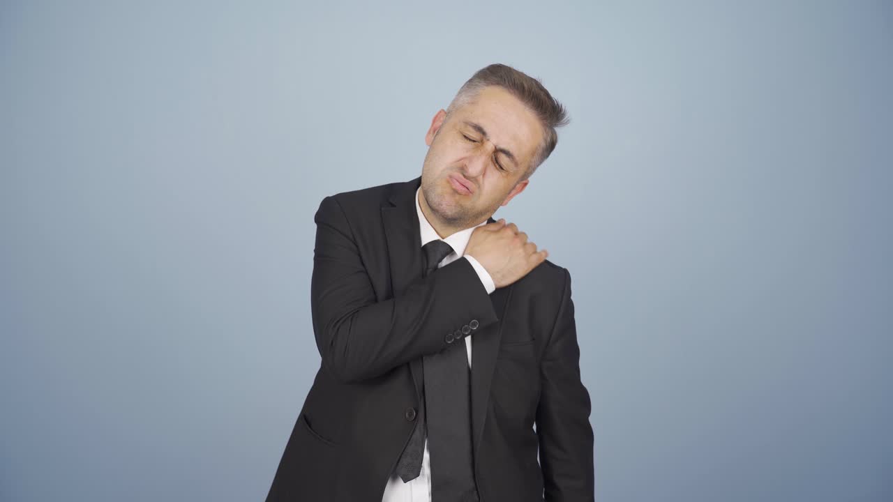 Businessman's shoulders hurt.