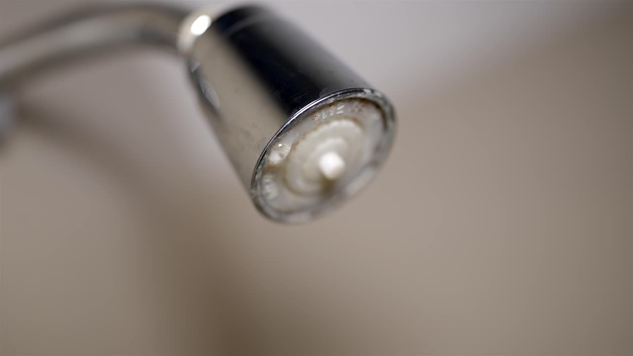 Dripping Shower Head Aerator Covered in Limescale, Detail Shot