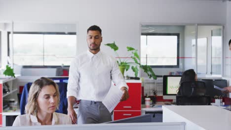 professional businessman giving document paper to his colleague in modern office in slow motion