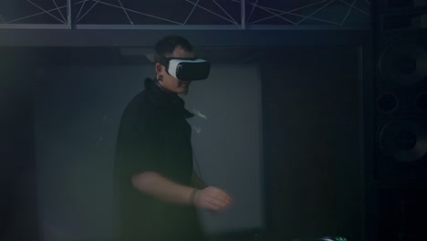 dj in vr-headset tanzt zu musik bei der mischkonsole im club