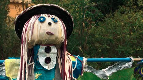 scarecrow made of recycled materials in rural garden field to scare birds away from agriculture crops reuse new life reinventing recycle eco green clean energy enviroment scary recycling friendly