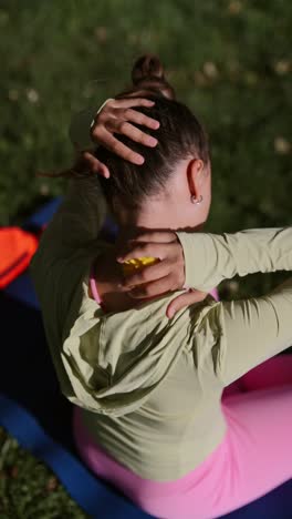 woman stretching her neck with a therapy ball