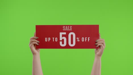 sale up to 50 percent off advertisement inscription on paper sheet in womans hands on chroma key