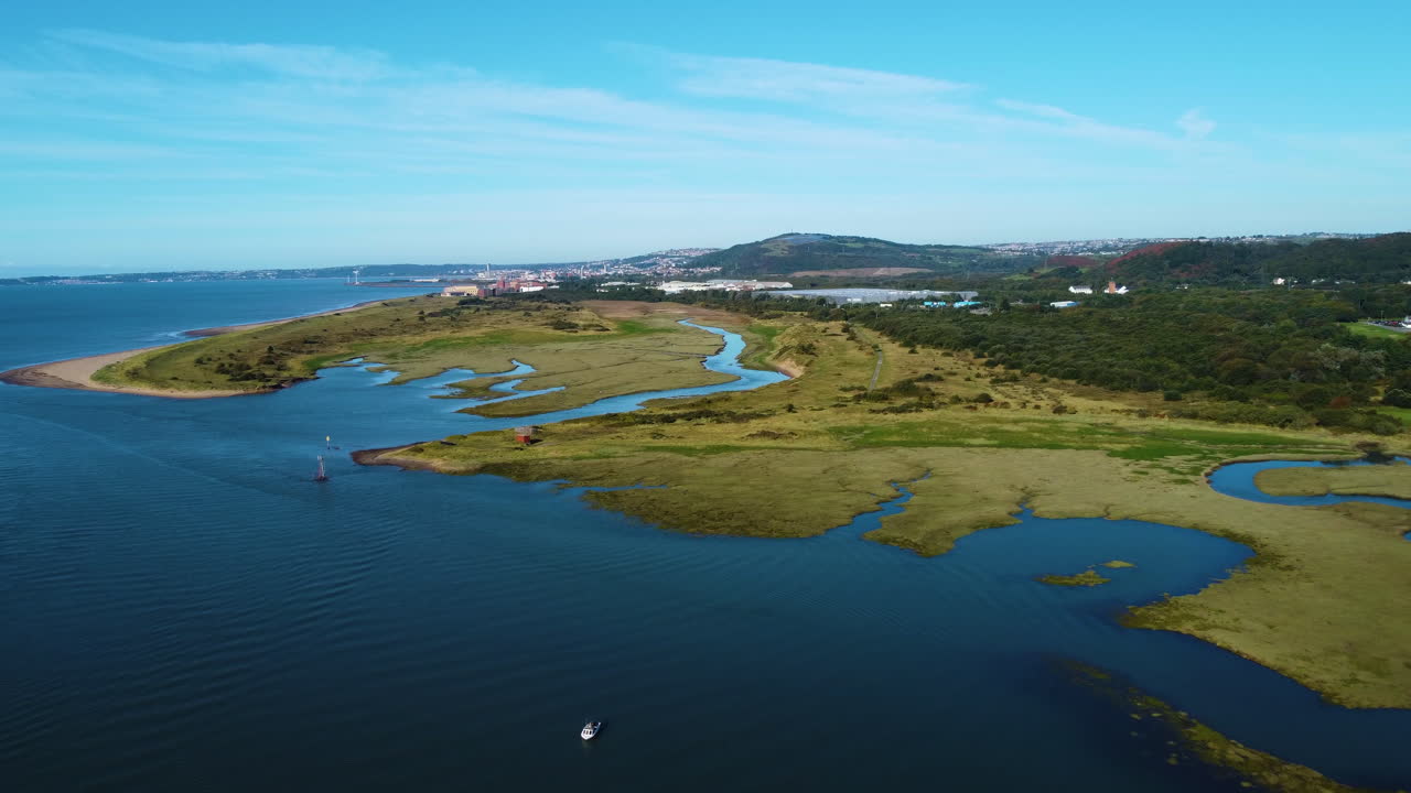 Aerial of Wide Landscape Towards Swansea Bay at High Tide with Wetlands with Warehouse and University in Background