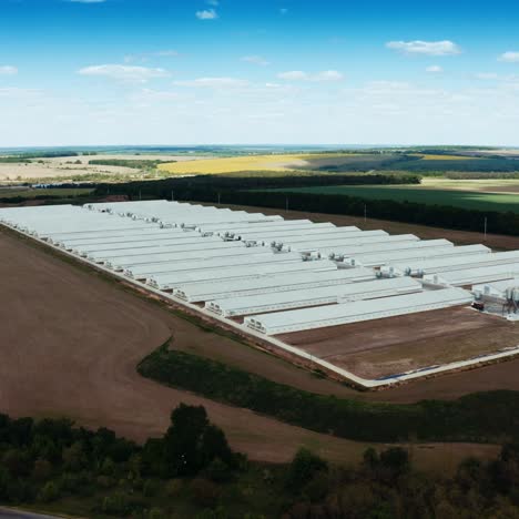 modern factory among nature. exterior of a large modern production plant. white industrial buildings on the field. aerial view.