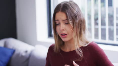 Woman-sneezing-on-her-elbow