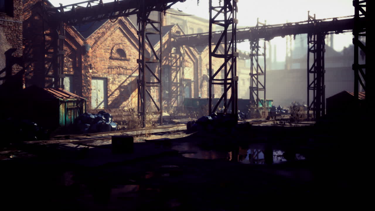 Abandoned industrial site with rusting structures in soft evening light