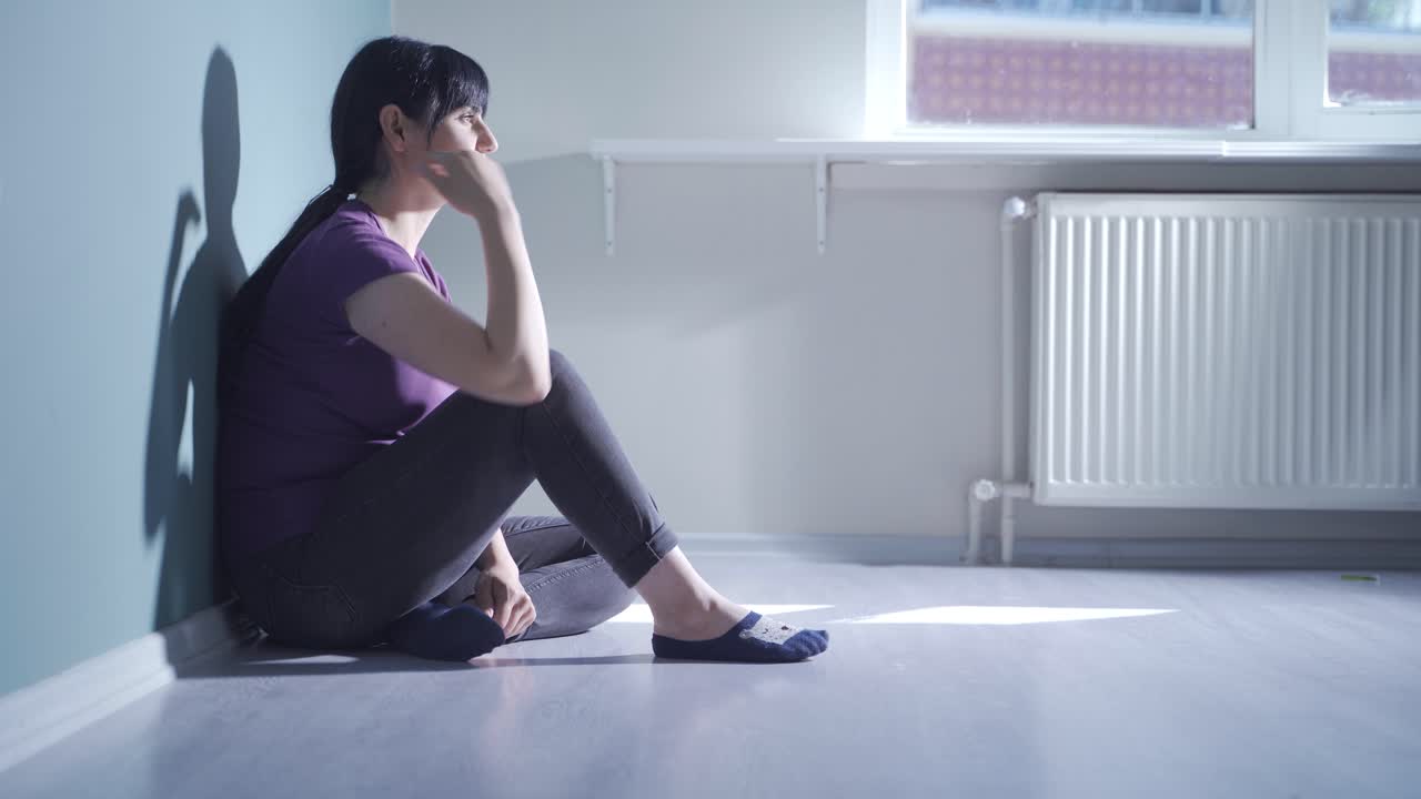 Depressed woman alone at home.