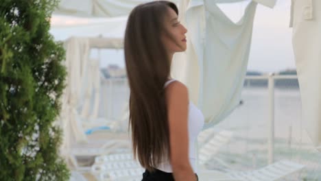 of a beautiful caucasian brunette in front of a mirror in a beauty salon of a beautiful caucasian brunette in front of a mirror in a beauty salon she looks at herself enjoying her smooth velvety skin and her beauty