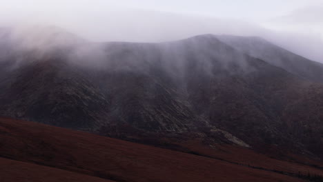 ogilvie mountains on a misty day in yukon, canada - drone shot
