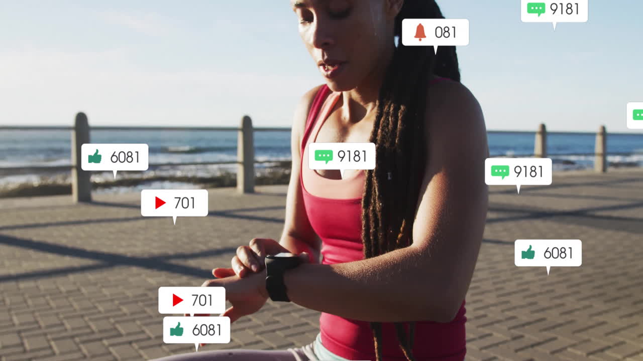 Checking smartwatch for social media notifications, woman walking by seaside