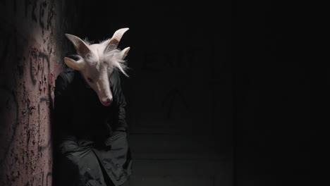 goat mask in a dark alley