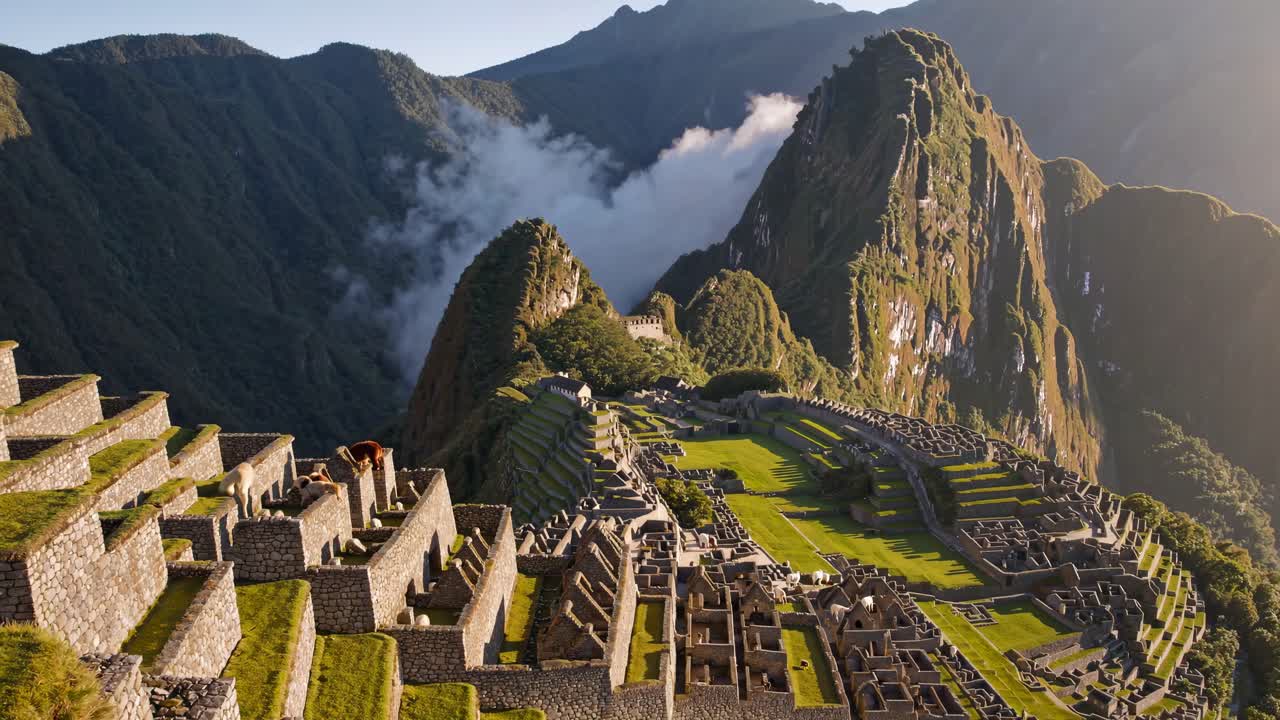 Aerial view of Machu Picchu at sunrise, showcasing ancient ruins and lush mountains