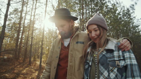 happy couple chatting on walk in forest