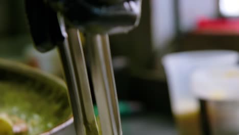 Chef places seafood white sauce pasta on plate with tongs