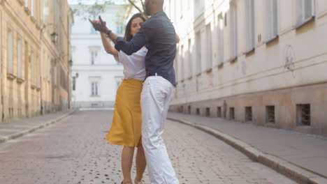 interracial couple dancing bachata in the old town street 6