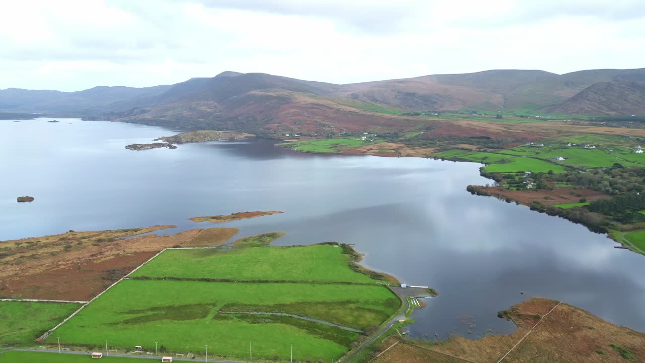 Aerial view of Waterville, Ireland with serene lake and lush green fields