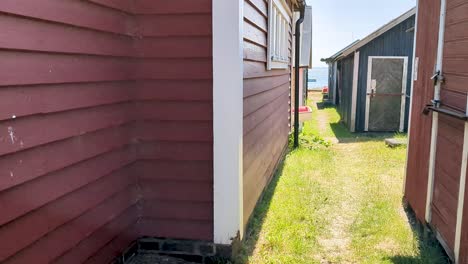 4k 60fps cozy swedish fishing sheds on harbor on a sunny day - truck shot