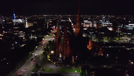 aerial night view of a city with a cathedral
