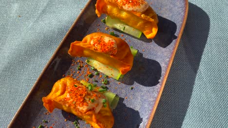 delicious mini empanadas with cucumber and chili dust in a restaurant, tasty spanish argentinian food in marbella estepona, 4k top view