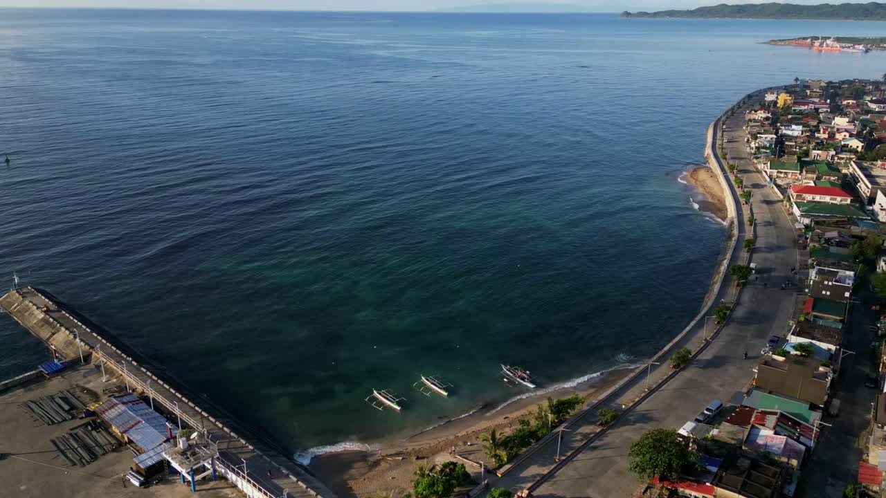 Picturesque aerial timelapse of tropical island province setting with turquoise ocean cove at Imelda Boulevard, Virac, Catanduanes, Philippines.