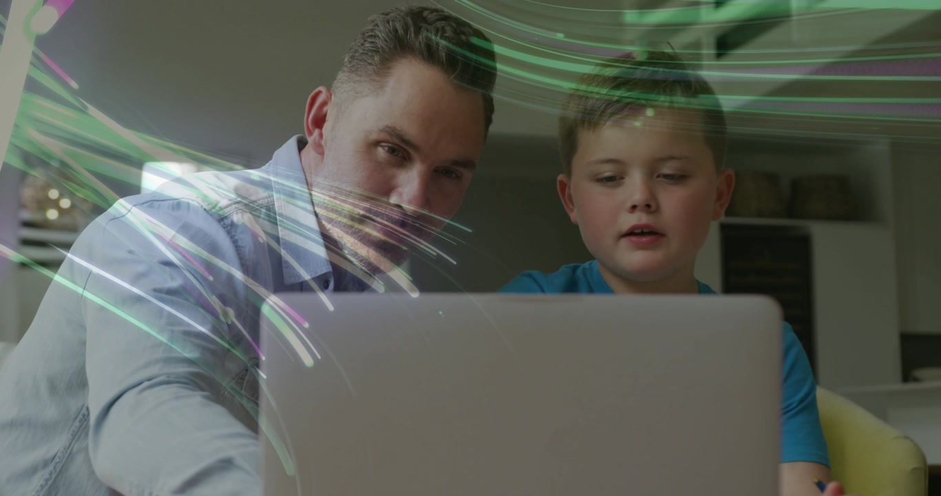 Parent leaning in and pointing at laptop, child learning while animated light streaks overlaying