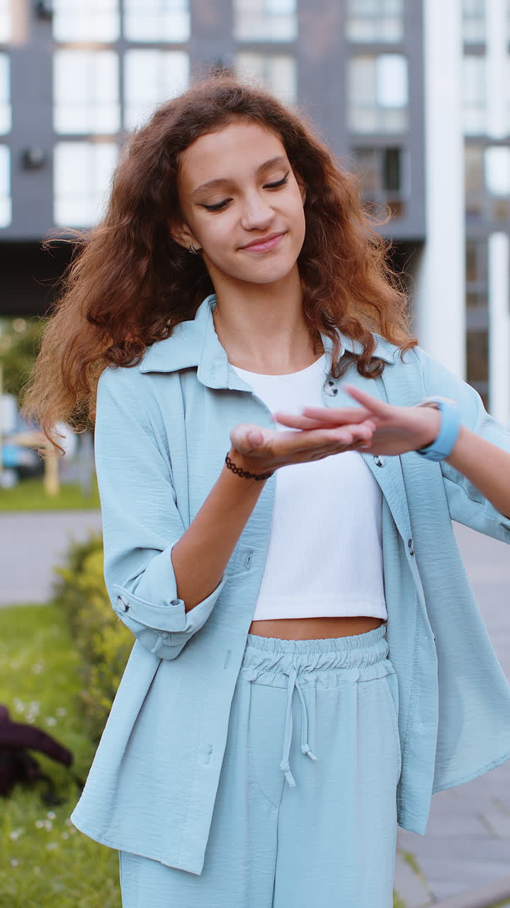 Cheerful rich teen girl showing wasting throwing money win lottery share celebrate in city street