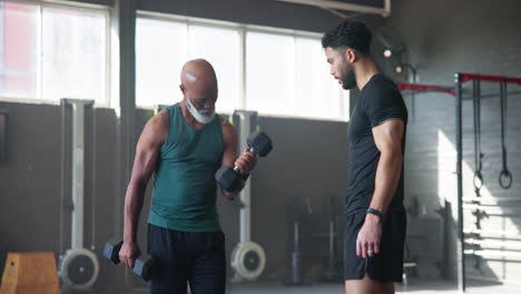 personal trainer instructing his client on a weight lifting exercise in the gym