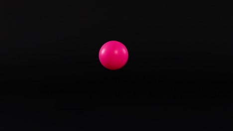 a pink sphere moves vertically against a dark backdrop, showing dynamic motion and rhythm.